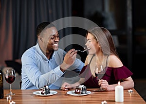 Loving African American Guy Sharing Dessert With His White Girfriend, Feeding Her