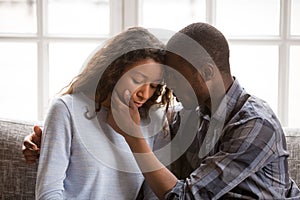 Loving African American husband touching wife face