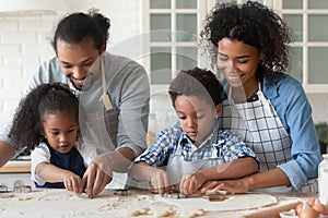 Loving African family cooking together in modern kitchen