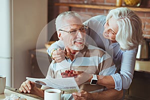 Loving aged couple enjoying their breakfast