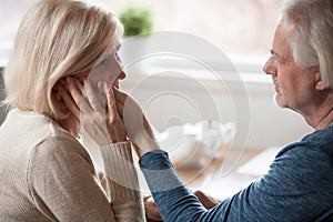 Loving aged husband touch and caress beloved wife photo