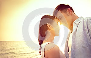Loving asian young couple kissing at sunset. Valentine`s day