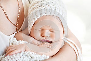 Loving baby sleeping in mother`s hands. Closeup picture