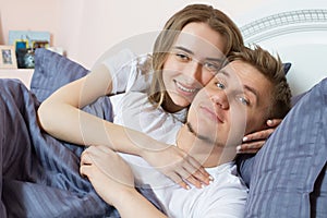 Loving beautiful couple in bed in the morning, loving family - heterosexual couple