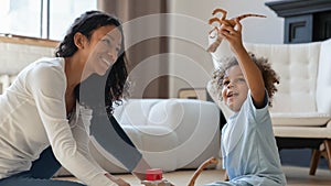 Loving biracial mom play with little son