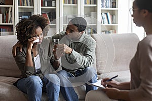 Loving black husband comforting crying wife, attend family therapy