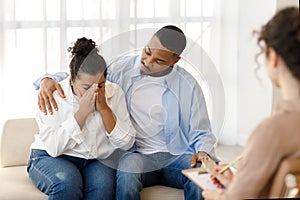 Loving black man comforting crying girlfriend, attend family therapy