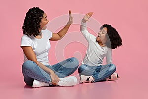 Loving Black Mother And Daughter Giving High Five To Each Other