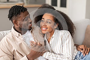 Loving Black Young Couple Embracing Smiling To Each Other Indoor
