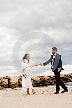 Loving bride and groom near the sea.