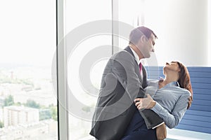 Loving business couple dancing in office