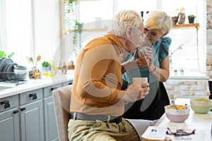 Loving caring man kissing the hand of his elderly wife