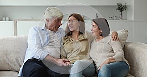 Loving caring senior parents hugging adult daughter with tenderness