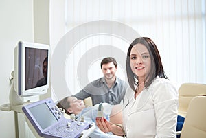 Loving couple attending doctor for pregnancy ultra sound procedu