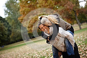 Loving couple in autumn park laughing