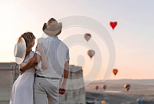 A loving couple among the balloons. A couple in love in Cappadocia. Couple in Turkey. Honeymoon in the mountains.