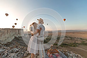 A loving couple among the balloons. A couple in love in Cappadocia. Couple in Turkey. Honeymoon in the mountains.