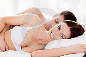 Loving couple in bed.