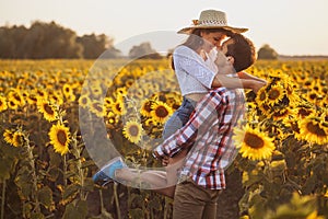 Loving couple in a blooming sunflower field