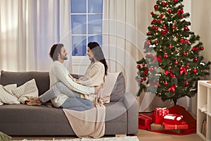 Loving Couple Celebration New Year Near Christmas Tree at Home