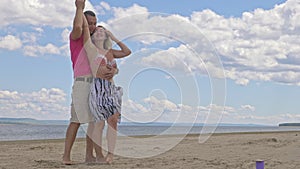 Loving couple on the coast, dancing. This is their love story. They hug and kiss. A man and a woman are happy and joyful