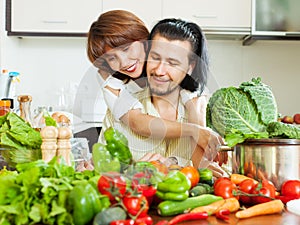 Loving couple cooking veggy lunch