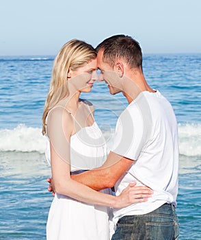 Loving couple cuddling at the beach