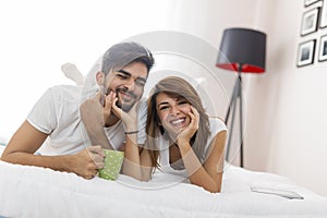 Couple drinking morning coffee in bed