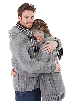 Loving couple cuddling up to each other smiling