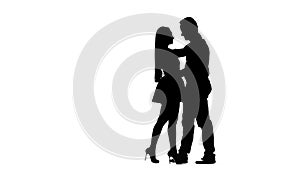 Loving couple is dancing Latin dances in the studio. Silhouette. White background