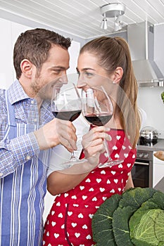 Loving couple drinking wine in the kitchen