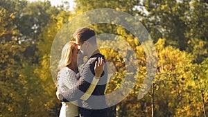 Loving couple embracing in autumn park, love in spite of difficulties, relations