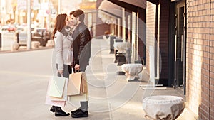 Loving couple embracing after shopping in fashion shops