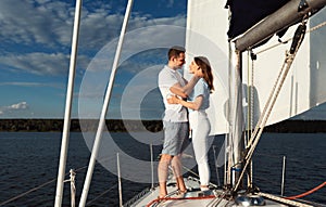 Loving Couple Embracing Standing On Sailboat Sailing On River Outdoor