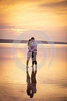 Loving couple embracing standing in water