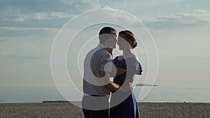 Loving Couple Embracing at Sunset on the Beach