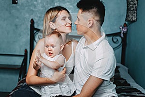 Loving couple embracing their adorable daughter