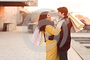 Loving couple embracing when walking after shopping