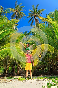 A loving couple enjoying the breathtaking views of the tropical sandy beach