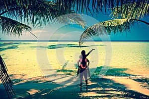 A loving couple enjoying the breathtaking views of the tropical sandy beach