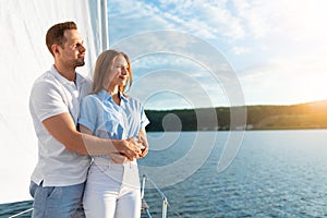 Loving Couple Enjoying Sailboat Ride Hugging Standing On Yacht Deck