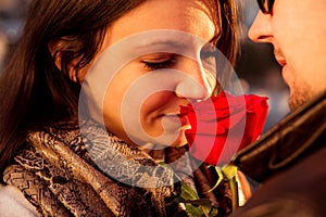 Loving couple enjoying the sun with red rose