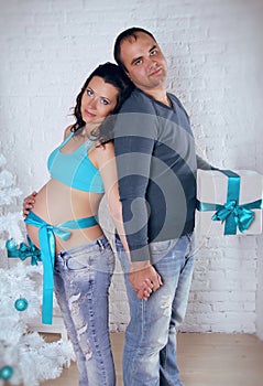 Loving couple family embracing with pregnant belly