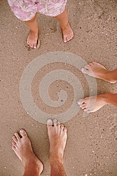 Loving couple feet in the sand