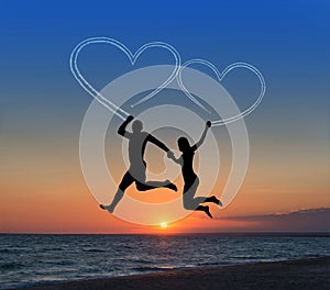 Loving couple flying it sky against sea beachand heart-shaped