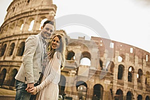 Loving couple in front of the Colosseum in Rome