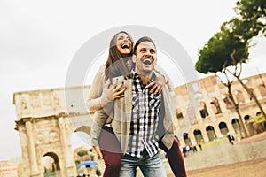 Loving couple in front of Colosseum in Rome
