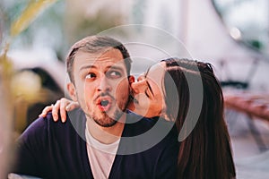 Loving couple. Girl bites her boyfriend`s ear