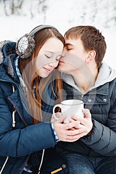 Loving couple having fun outdoors in winter