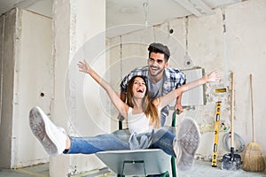 Loving couple is having fun while renovating their home photo